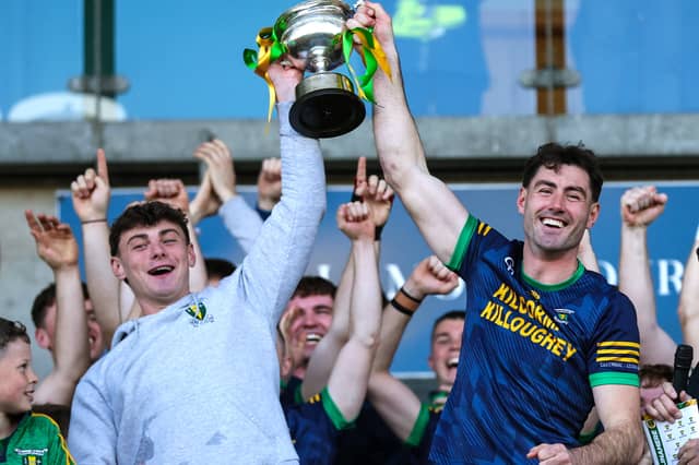 Jordan Quinn of Kilcormac-Killoughey lifts the Sean Robbins Cup alongside teammate Charlie Mitchell after the Offaly County Senior Club Hurling Championship final.
