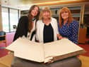Hannah Clarke, her grandmother Margaret Moloney and mother Anne Clarke with the University of Galway student register, showing the signature of Hannah’s great-grandmother, Mary C. Whyte. 