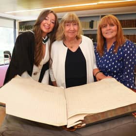 Hannah Clarke, her grandmother Margaret Moloney and mother Anne Clarke with the University of Galway student register, showing the signature of Hannah’s great-grandmother, Mary C. Whyte. 