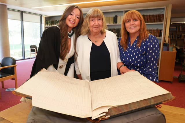 Hannah Clarke, her grandmother Margaret Moloney and mother Anne Clarke with the University of Galway student register, showing the signature of Hannah’s great-grandmother, Mary C. Whyte.