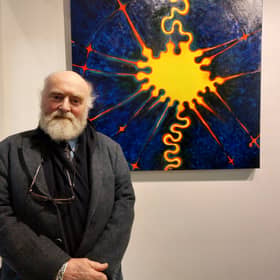 ​Birr artist Chris O’Donoghue standing in front of one of his paintings. The exhibition runs until the end of November and the paintings are for sale.
