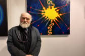 ​Birr artist Chris O’Donoghue standing in front of one of his paintings. The exhibition runs until the end of November and the paintings are for sale.