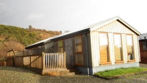 WATCH: This affordable shoreside log cabin is a refreshing spin on the usual holiday park home