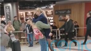 WATCH: Crowd watches on as man proposes to flight attendant in Dublin Airport 