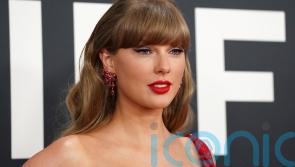Taylor Swift sparks speculation in all-red ensemble at Grammys