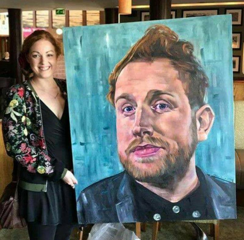 Claire Guinan with her portrait of singer Gavin James