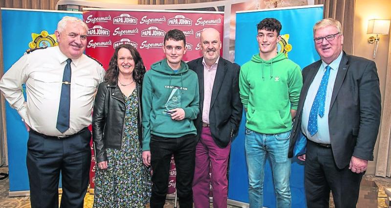Tullamore Garda District Award winner James Saunders pictured with family, receving his award from John Scanlon, Chief Superintendent Garda Division and Mr. Pat McDonagh, CEO Supermac's.