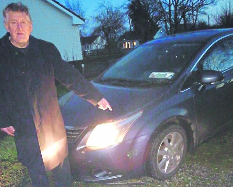 Pius Luby points out the damage to his car caused by a fox on the Cloghan to Blueball road, the R357.