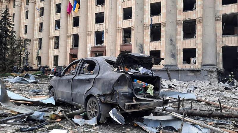 A burnt car is seen in front of a damaged City Hall building, in Kharkiv (Ukrainian Emergency Service/AP)