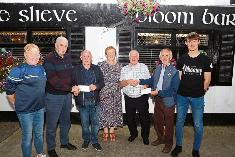 Lucky GAA club lotto winner collects massive prize winning cheque