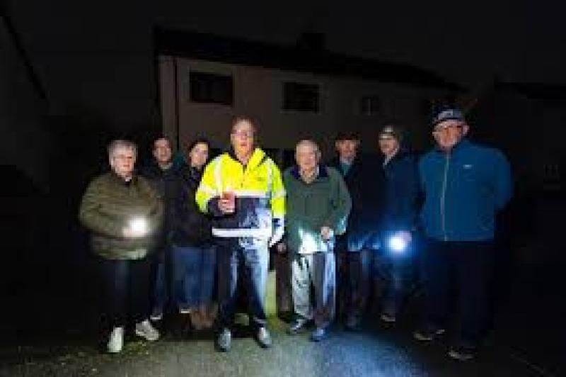 Residents of The Green housing estate Clara, pictured last year with flashlamps to light their way. The same situation has arisen this year and residents have been without public lights for five weeks