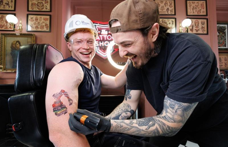 Ryan Kelly giving a temporary tattoo to social media personality  James Doyle