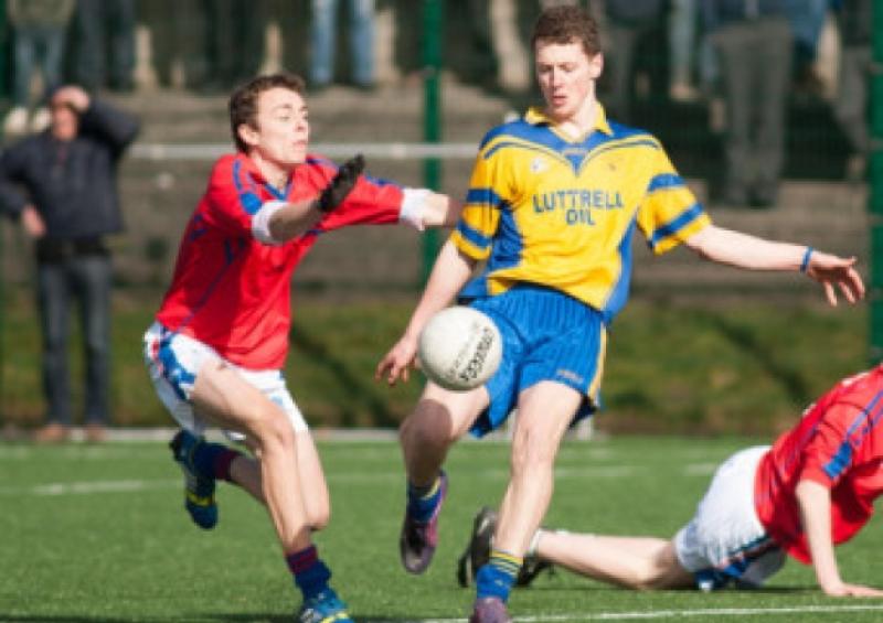 Colaiste Iosagains' Grham Weldon about to play this ball as Scoil Choilms' Paul O'Toole looks to block. Photo Denis Byrne.