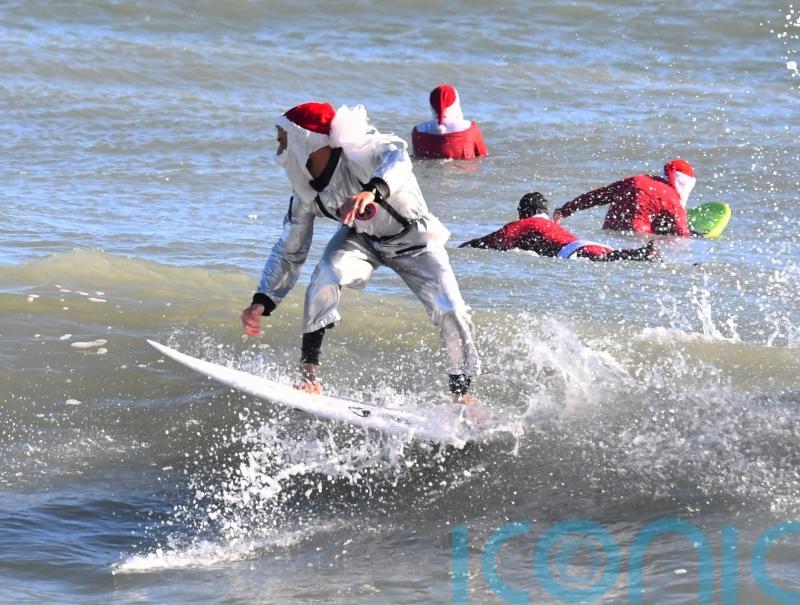 Frigid weather fails to stop Florida’s surfing Santas