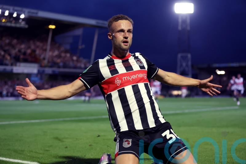 Grimsby hang on after 10-man MK Dons stage second-half fightback