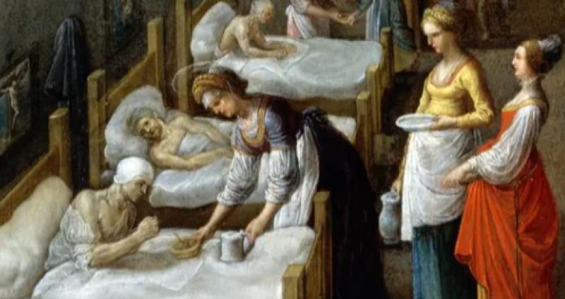 St Elizabeth offering a bowl of food to a patient