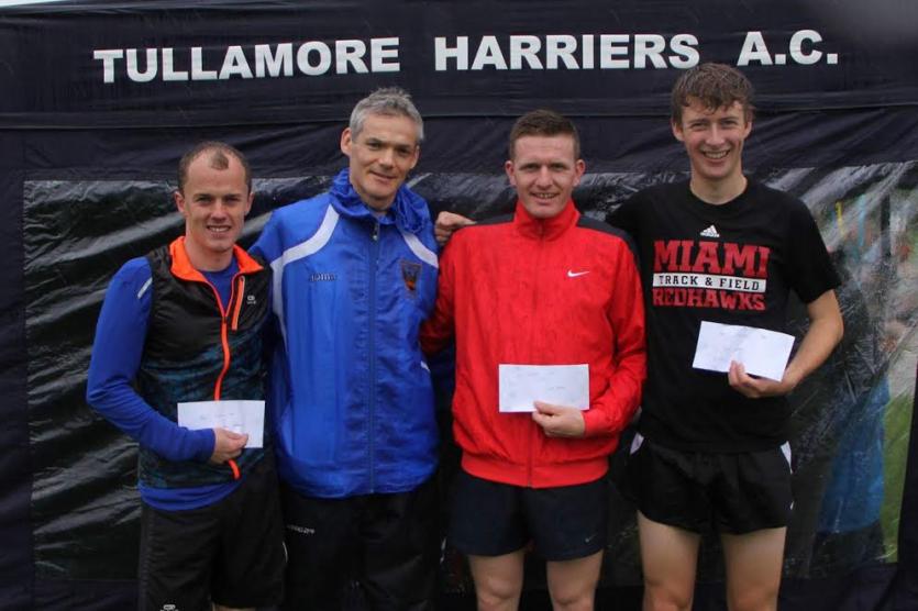 Darren Butler (Bank of Ireland) presenting the prizes to the 3000m medallists at the Bertie Quinn Track and Field. 
