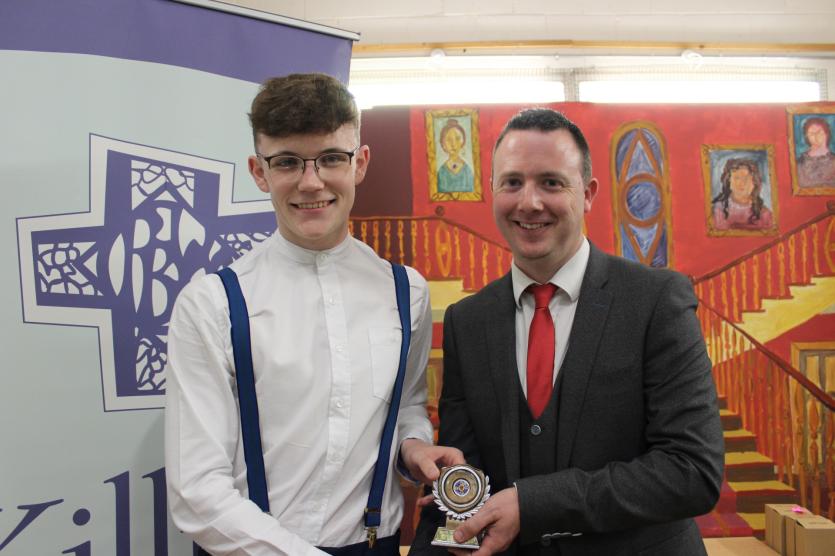 Killina Senior Footballer of the Year Adam Owens receiving his award from Deputy Principal Mr. Aidan Lawless.