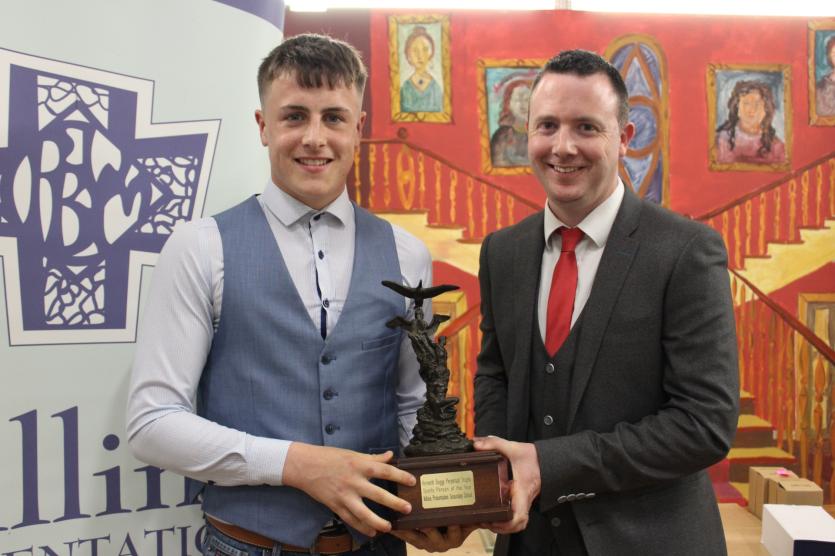 Kenneth Buggy Sportsperson of the Year Winner Shane O'Toole receives his award from Deputy Principal Mr. Aidan Lawless.