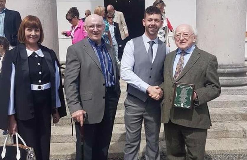 Gary Farrell is pictured with his parents Mary and Peadar as he shakes  hands with President Michael D. Higgins