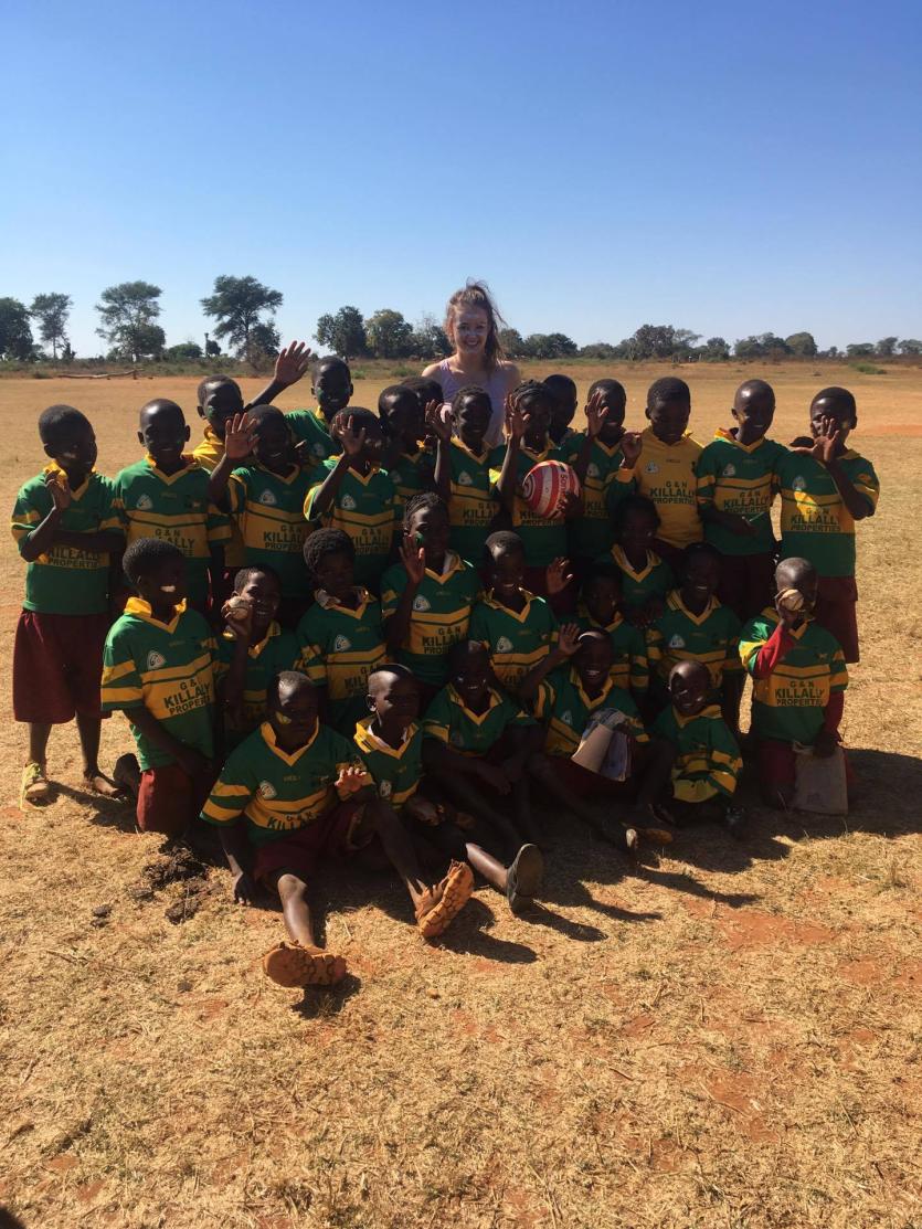 Rhode woman Chloe Cocoman pictured with some of her students in their new Rhode GAA jerseys