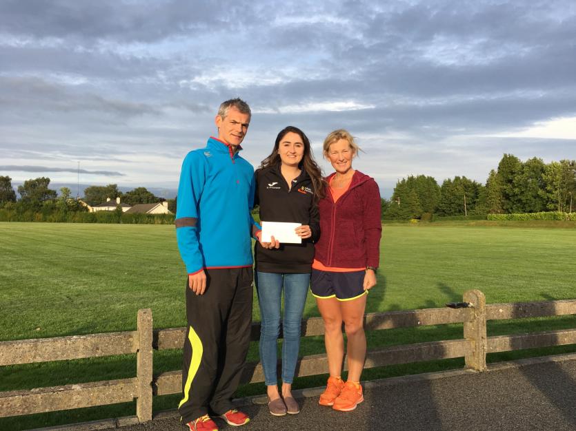 Niamh O'Connor being presented with a training bursary on behalf of the club by Ladies Captain Mary Daly and Offaly Athletics Chairperson Darren Butle