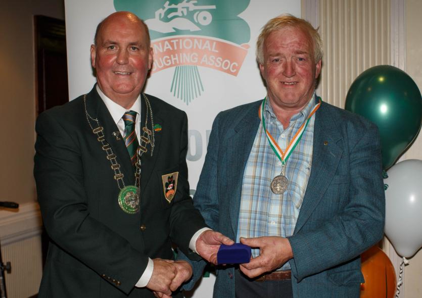 Frankie Gowing picks up his silver medal for the Standard 3 Furrow Reversible class from NPA President James Sutton