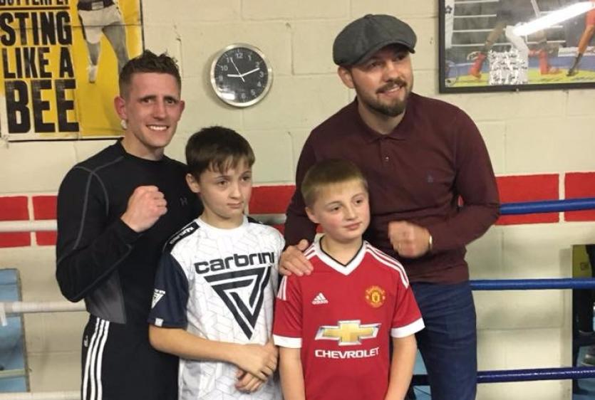 Former World Champion Andy Lee (R) and current pro fighter Eric Donovan (L) with young boxers in Edenderry