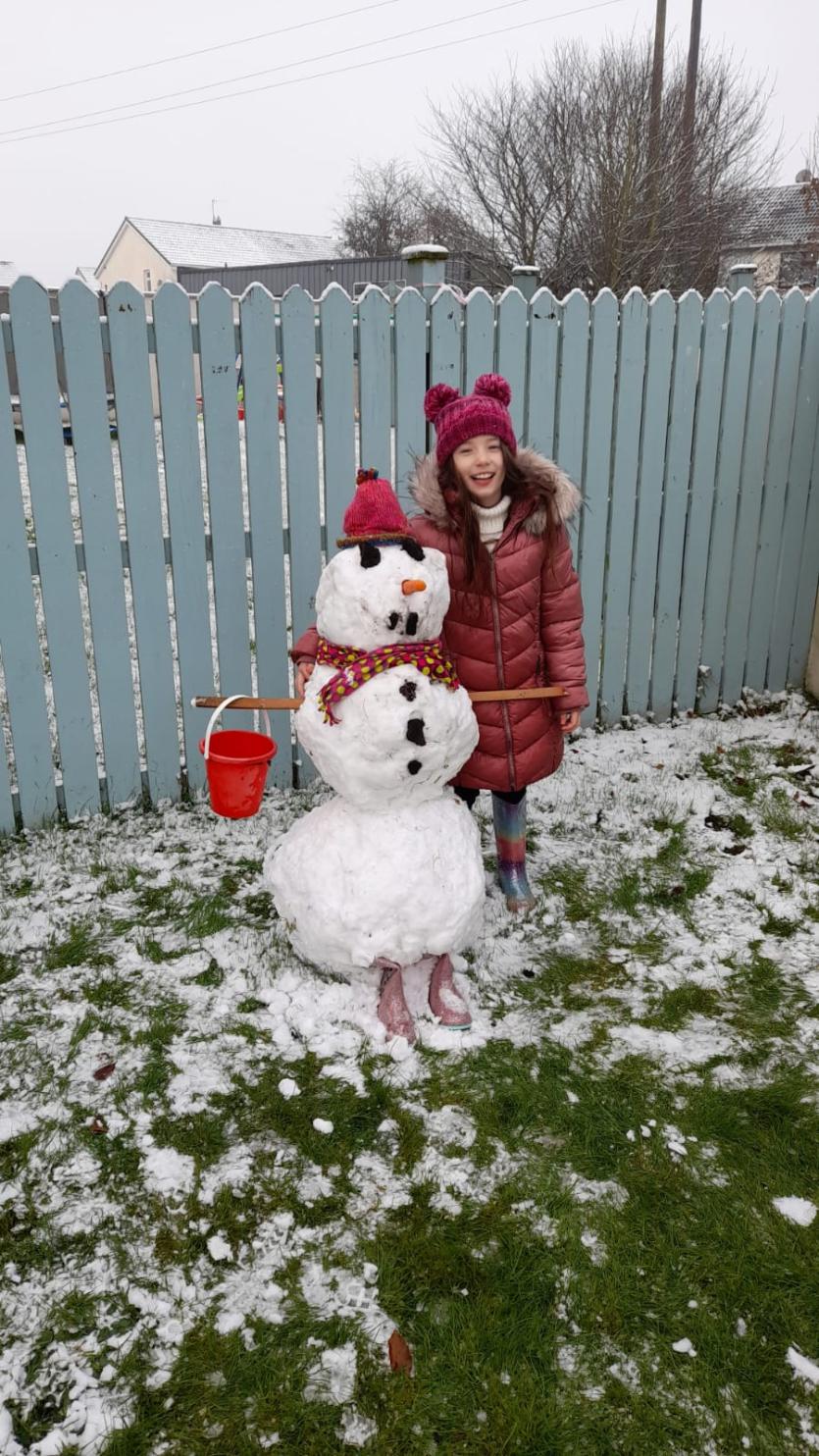 Isabelle having great fun building a snowman
